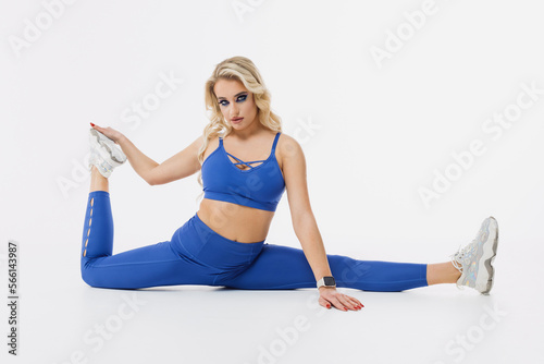 Doing sports every day. Young woman during stretching
