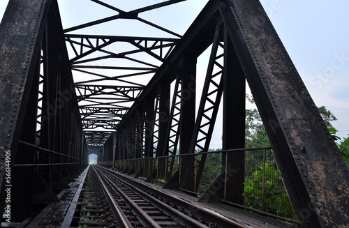 Fototapeta Naklejka Na Ścianę i Meble -  Vintage steel dark color rusty railway bridge on perspective shot