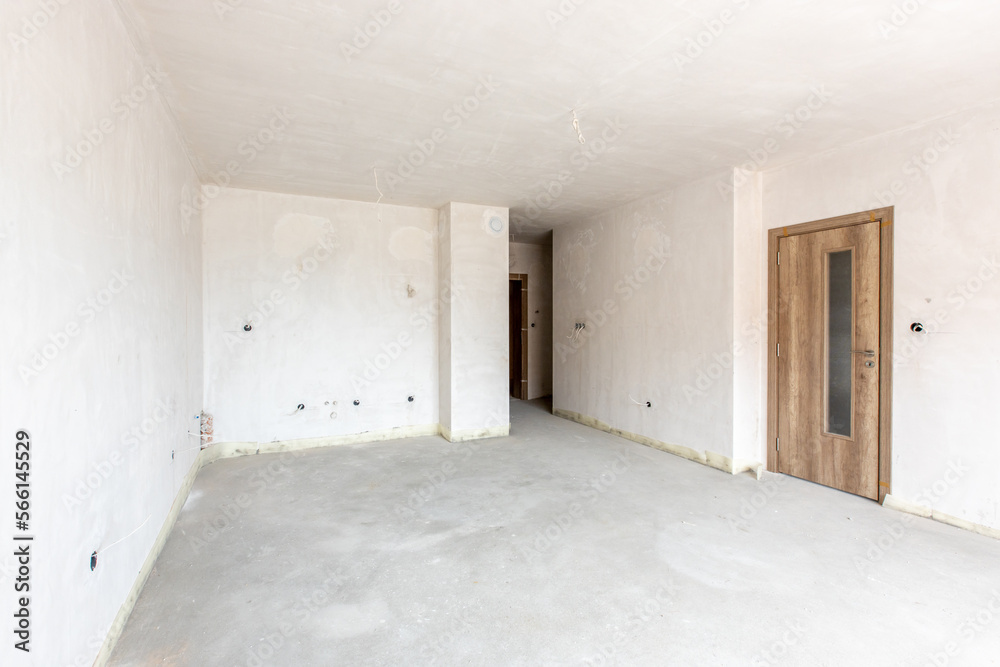 New empty room under construction. Plaster walls. New home. Concrete walls. Interior renovation. New empty room under construction. Plaster walls. New home. Concrete walls. Interior renovation.