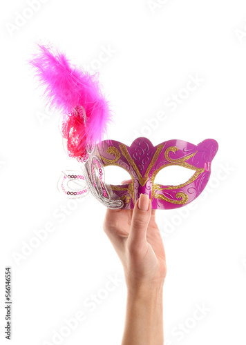 Woman with pink carnival mask for Purim holiday on white background