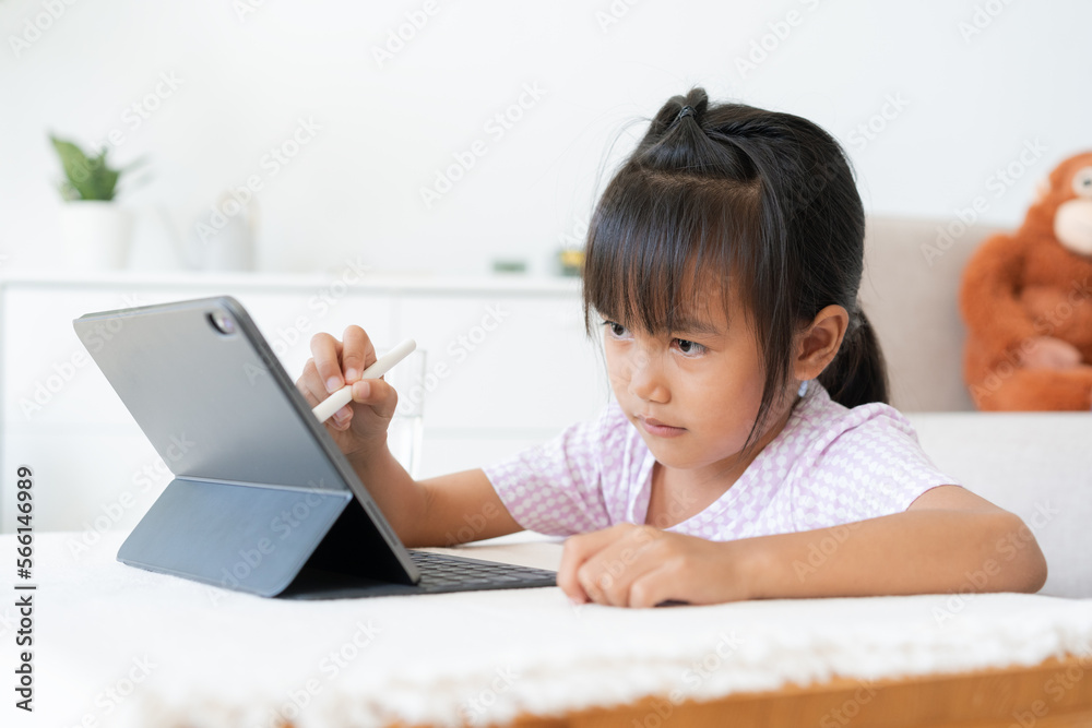 Education. Asian little girl learning and drawing with the online teacher on tablet digital Education. Asian little girl learning and drawing with the online teacher on tablet digital