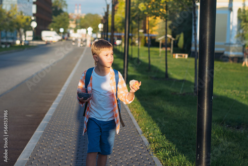Photos caucasian boy walking from school wearing school bag