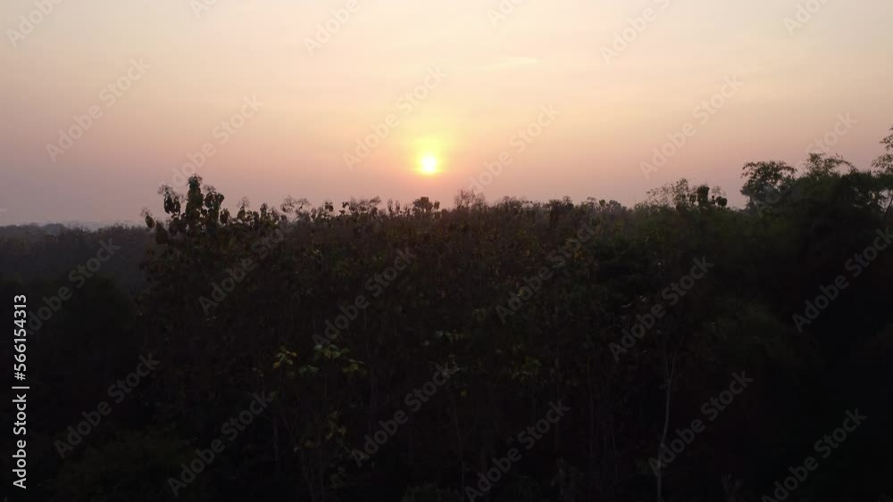 Aerial view of forest in fog with golden sun rays at sunrise in autumn. Beautiful rural landscape Aerial view of forest in fog with golden sun rays at sunrise in autumn. Beautiful rural landscape