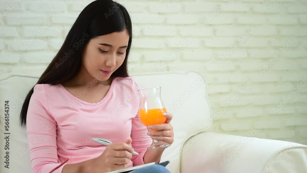 Women hands holding cold orange juice fresh fruit cool drinking. Asian women smile laugh look at camera health care home fitness lifestyle. Beautiful female pouring orange juice from cocktail bottle Women hands holding cold orange juice fresh fruit cool drinking. Asian women smile laugh look at camera health care home fitness lifestyle. Beautiful female pouring orange juice from cocktail bottle