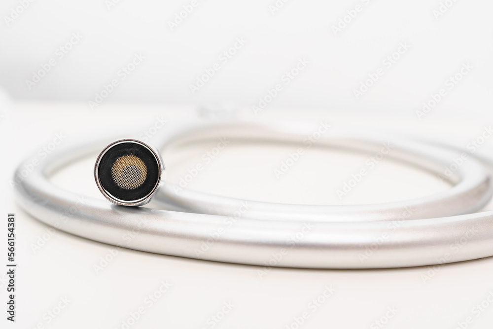 New flexible rubber shower hose on a white background. New flexible rubber shower hose on a white background.