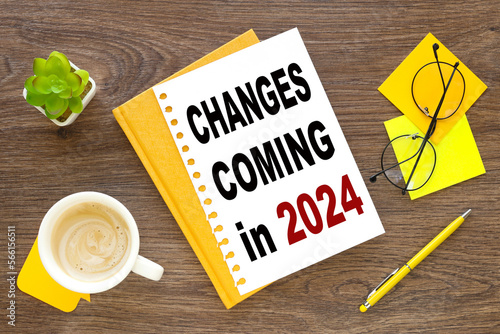 CHANGE COMING IN 2024. red and black font on white paper on the table near the cup of coffee.