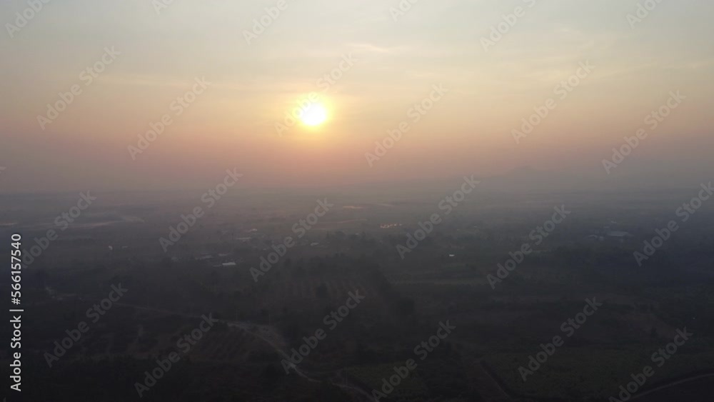 Aerial view of farmland in fog with golden sunlight at sunrise in spring. Beautiful rural landscape Aerial view of farmland in fog with golden sunlight at sunrise in spring. Beautiful rural landscape