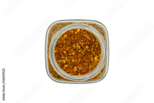 Chili powder in a glass jar, top view, isolated on white