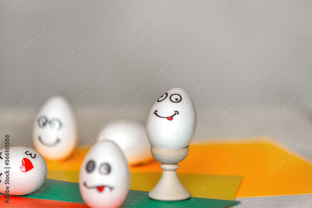 stickers with different emotions are pasted on white eggs, copy space .the concept of communication and emotions in social networks, unusual decoration of easter eggs
