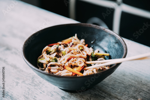 View osf asian noodles udon with pork close-up in a bowl on the table. photo