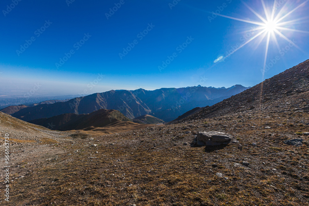 Big Almaty Gorge in the rays of the bright sun from the pass under the Big Almaty Peak