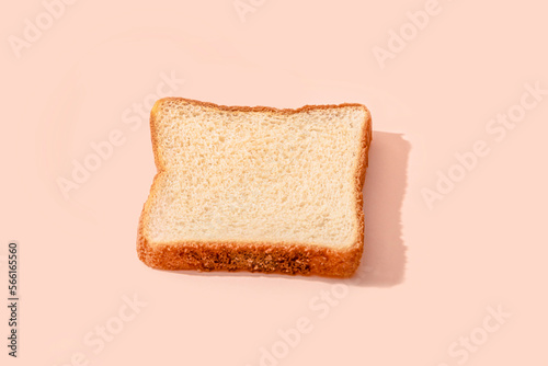 Slice of bread over peach background photo