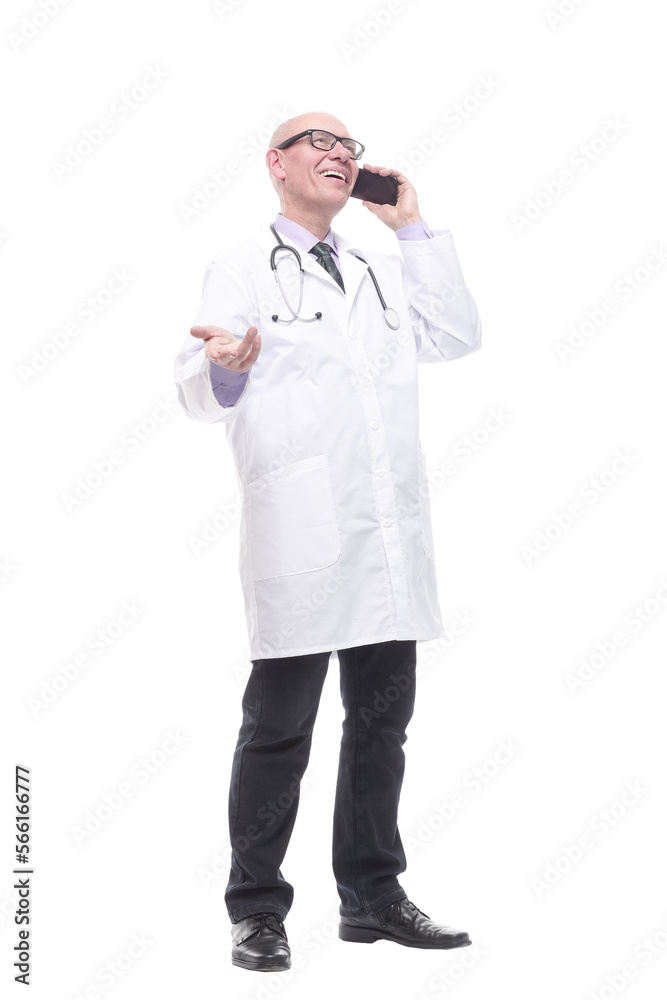 in full growth. smiling doctor with a smartphone. in full growth. smiling doctor with a smartphone.