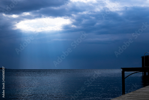 Sun rays breaking from clouds over the sea