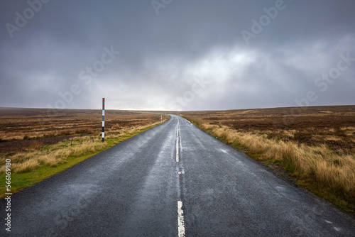 Empty road amidst field under storm clouds, County Durham, England photo
