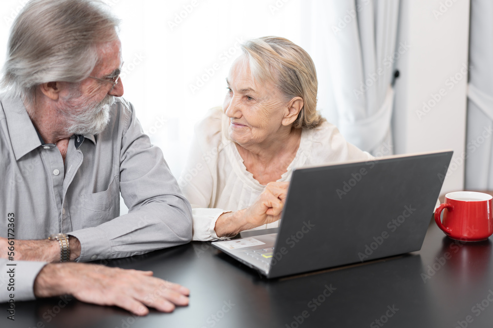 Older caucasian couple with tablet computer in living room at home Older caucasian couple with tablet computer in living room at home