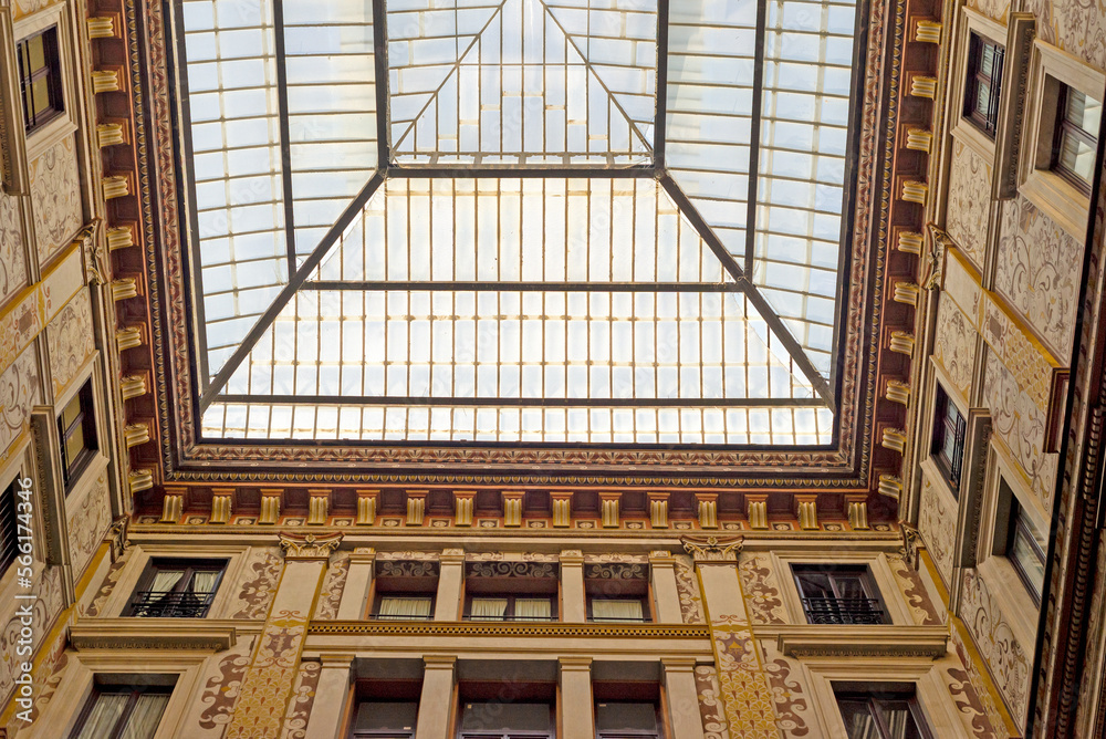 Part of a building and a glass roof in Rome. Windows, walls, facades, ornamentation.