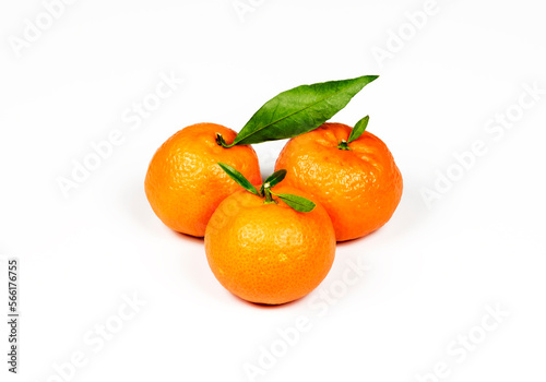 Three orange ripe mandarins on a white background