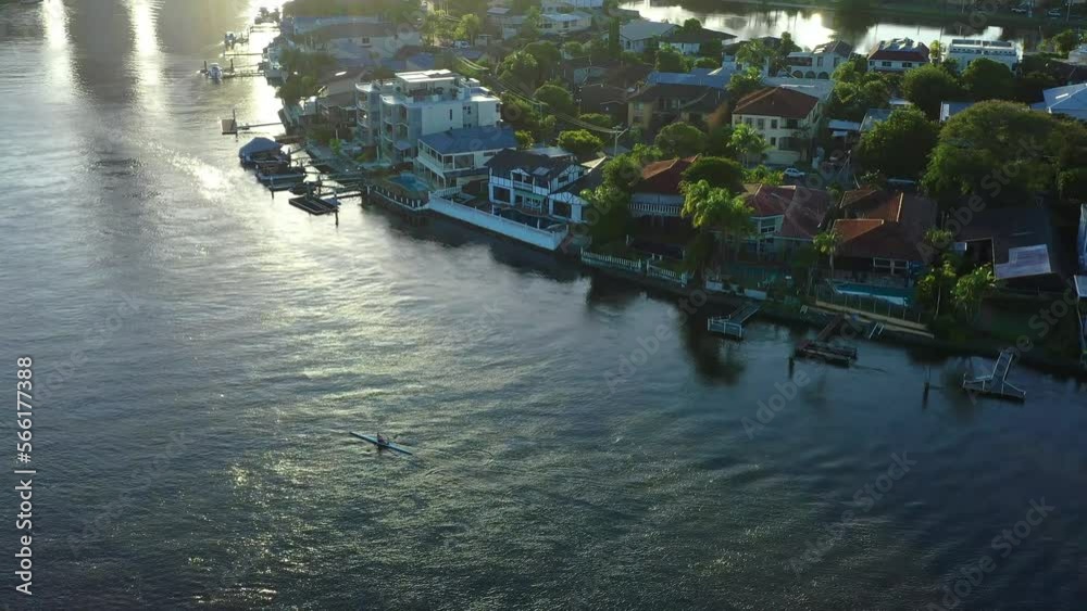 Main canal on the Gold Coast Early Morning rowers, on shimmering water Main canal on the Gold Coast Early Morning rowers, on shimmering water