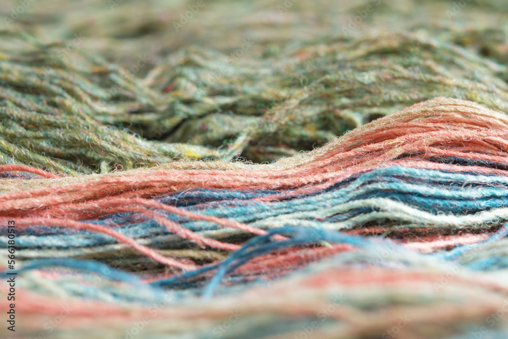 Threads from natural organic sheep wool. Close-up, macro. Two unwound skeins of green and rainbow knitting yarn. Threads from natural organic sheep wool. Close-up, macro. Two unwound skeins of green and rainbow knitting yarn.