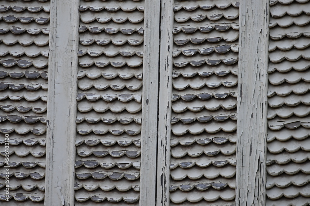 A weathered and very old wooden window protection in Spain.