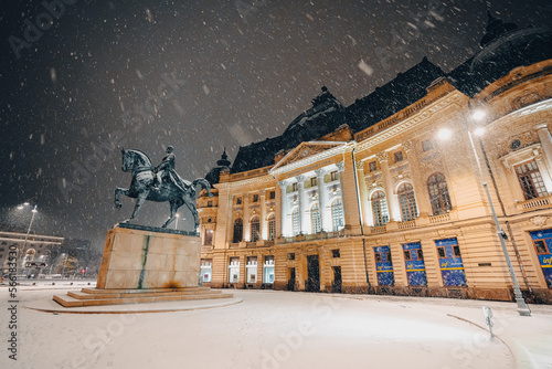 Winter night in Bucharest. Central University Library Carol I landmark building under snowfall during a winter evening in Bucharest, Romania, 2023.