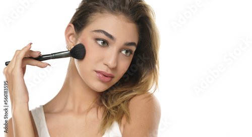 Woman using make-up brush, isolated on white background