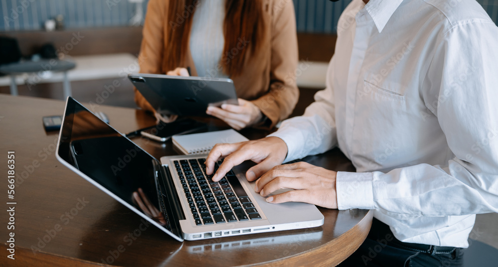 Fototapeta premium Team business meeting presentation. Hand businessman working project in modern office.Laptop computer and tablet and smart phone on white desk in morning light