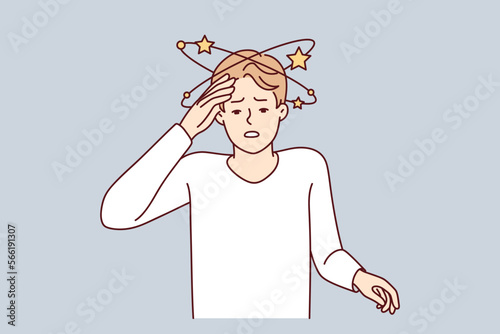 Suffering man experiencing pain in head after severe injury puts hand on forehead. Guy suffers from dizziness or needs to take drugs against intracranial pressure. Flat vector illustration