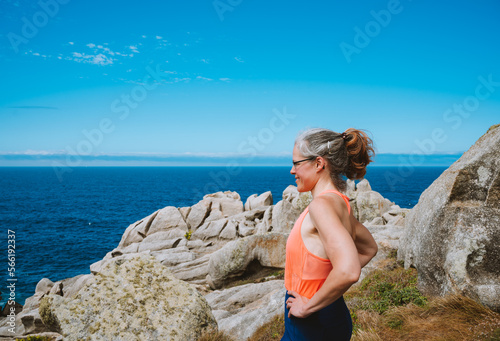 Woman in sportswear admiring the seascapes.