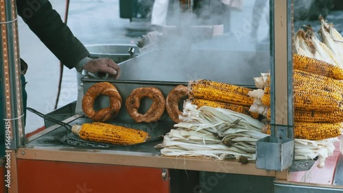 peddler man cooking corn on the grill. food and cooking concept