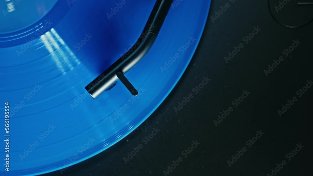 Endless seamless loop of vintage record player play sound. Needle on turntable touch bright blue record, spinning in dj set