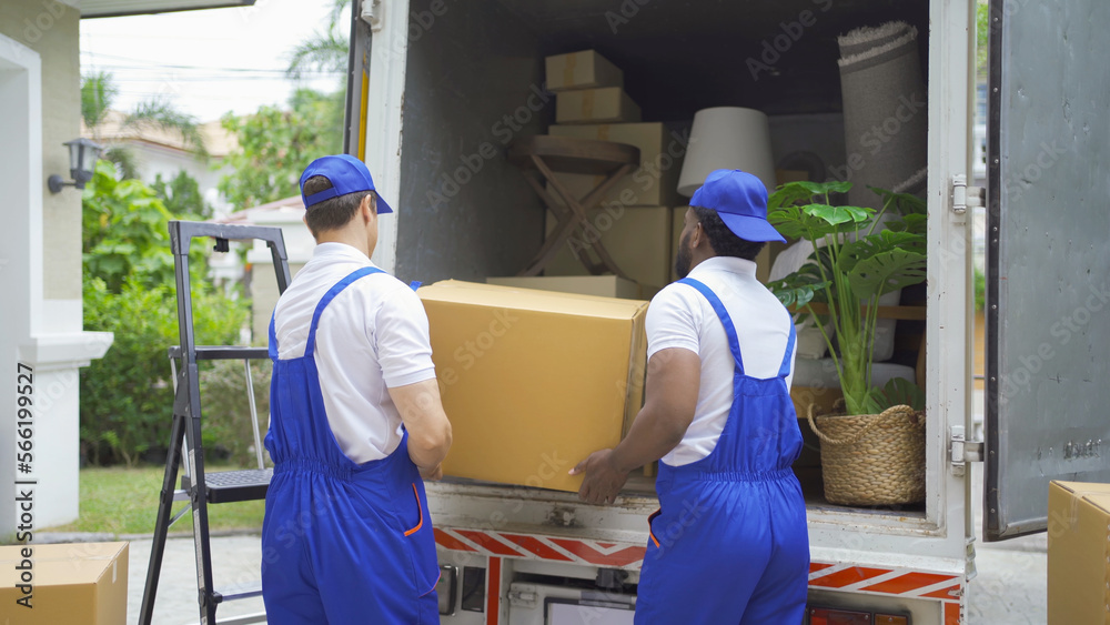 Team of employee workers with a truck car moving house for customers, delivering boxes with uniform.Vehicle transportation. Shipping and packaging business occupation service company. People lifestyle Team of employee workers with a truck car moving house for customers, delivering boxes with uniform.Vehicle transportation. Shipping and packaging business occupation service company. People lifestyle