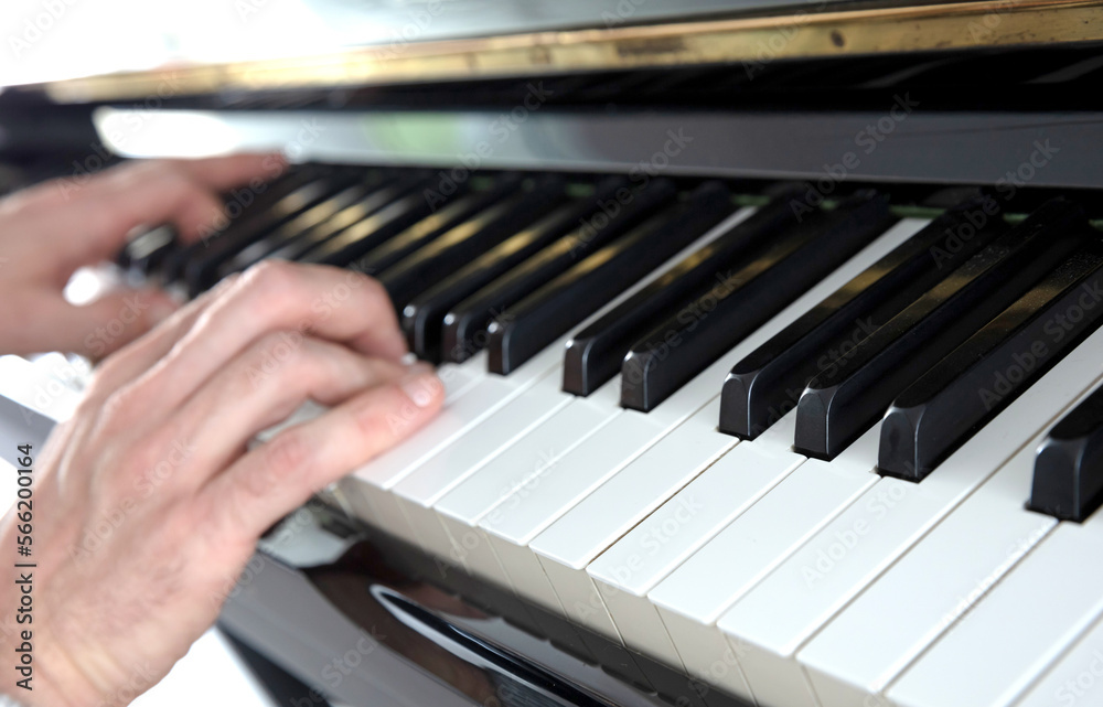 Hands playing music on piano