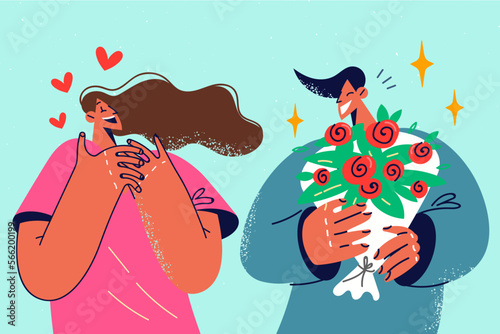 Loving man present flowers to excited woman 