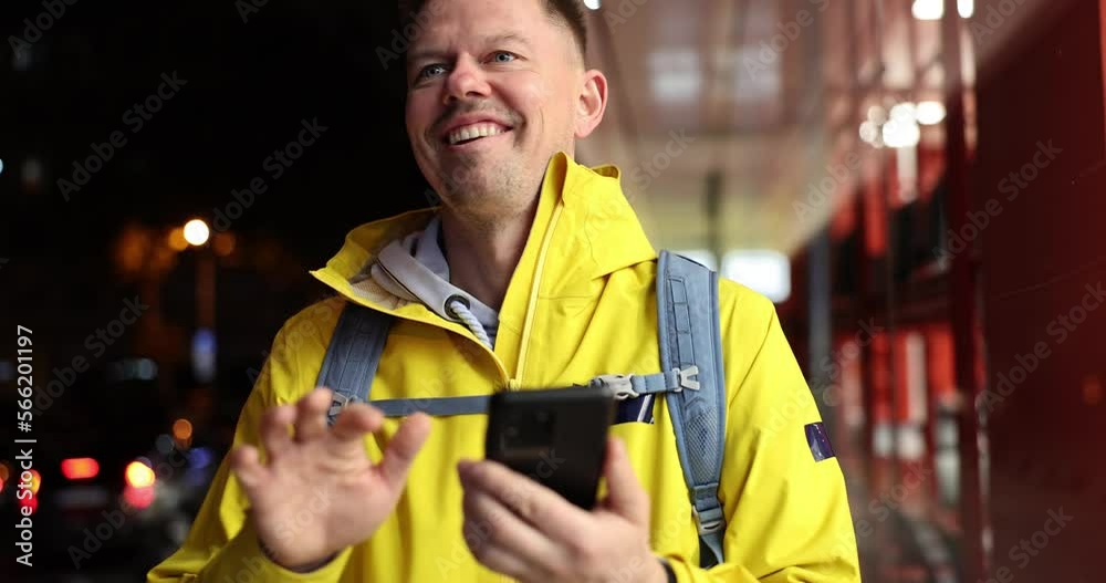 Male courier looking at mobile phone and waving to customer for food delivery 4k movie slow motion Male courier looking at mobile phone and waving to customer for food delivery 4k movie slow motion