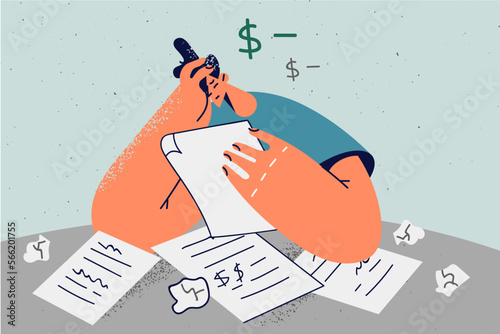 Unhappy man distressed with debt paperwork 
