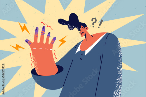 Unhealthy man frustrated with tremor in hands 