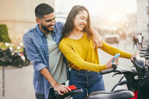 Photography Young couple renting electric bicycle with smartphone app - Soft focus on man fa