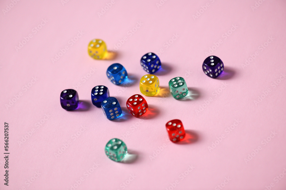 Close-up of colorful dice over pink background Close-up of colorful dice over pink background