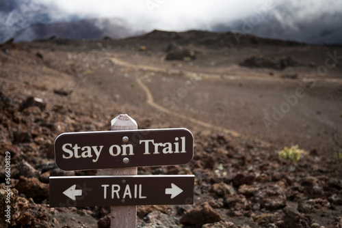 A sign telling hikers to stay on the trail in Haleakala crater. Hiking off-trail leads to significant soil erosion in the delicate volcanic soils. photo