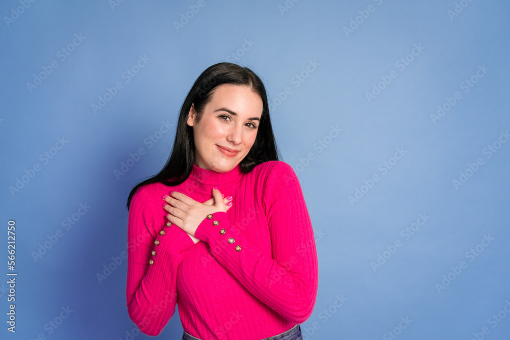 Smiling woman with hands on chest Smiling woman with hands on chest