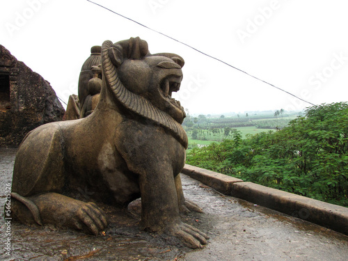 An ancient roaring lion sculpture on the roof of the rock cut caves at Undavalli near Vijayawada in Andhra Pradesh, India. photo