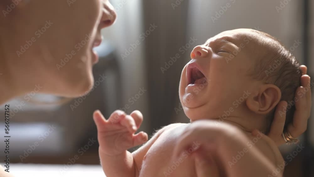 Slow Motion Shot of a Mother Holding and Talking to her New Born Baby While he Cries. Authentic Shot of a Woman New to Motherhood Trying to Sooth her Little Baby By Talking to him Slow Motion Shot of a Mother Holding and Talking to her New Born Baby While he Cries. Authentic Shot of a Woman New to Motherhood Trying to Sooth her Little Baby By Talking to him