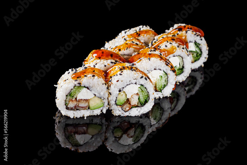 sushi roll with sesame avocado cucumber eel and Philadelphia cheese on a black mirror background