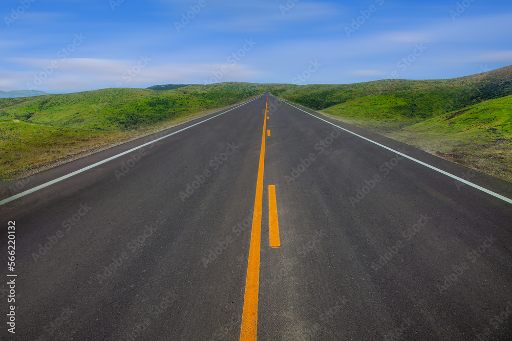 Driving on empty road to the mountains