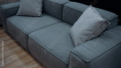 Blue sofa with gray cushions, slow shot from above. 4k video.