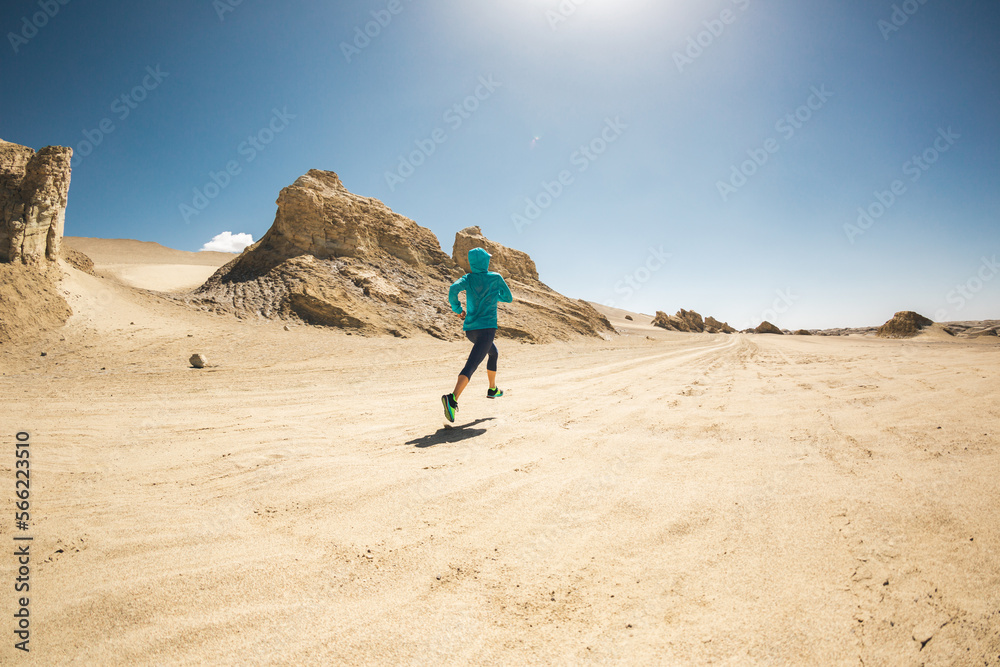 Fitness woman trail runner cross country running on sand desert