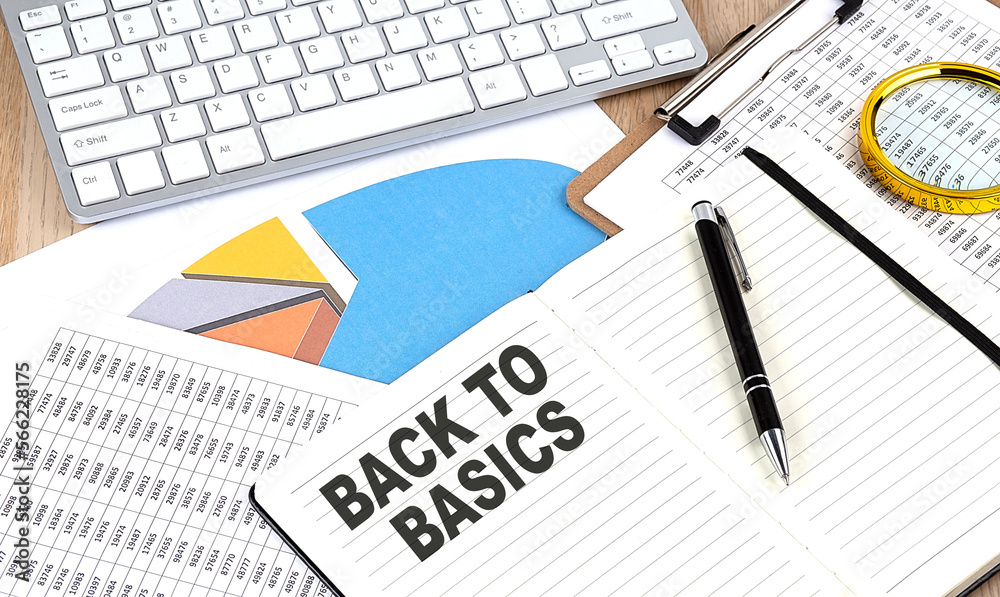 BACK TO BASICS text on notebook with chart and keyboard BACK TO BASICS text on notebook with chart and keyboard