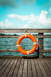 orange lifebuoy on the pier